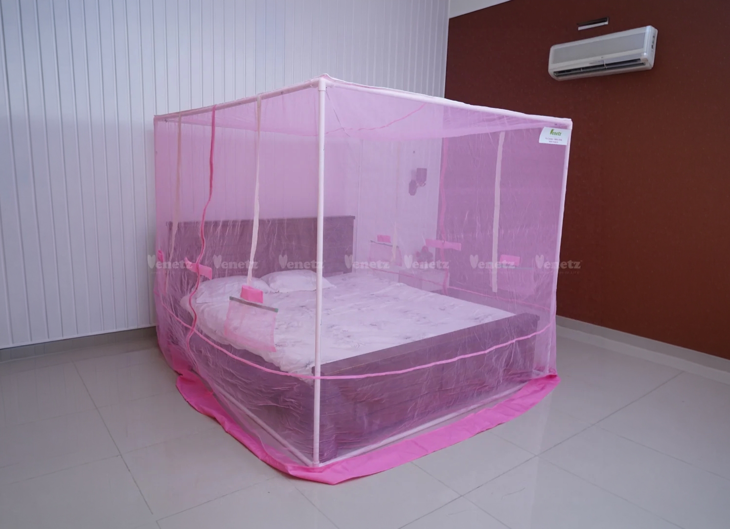 Venetz framed mosquito net installed on a bed